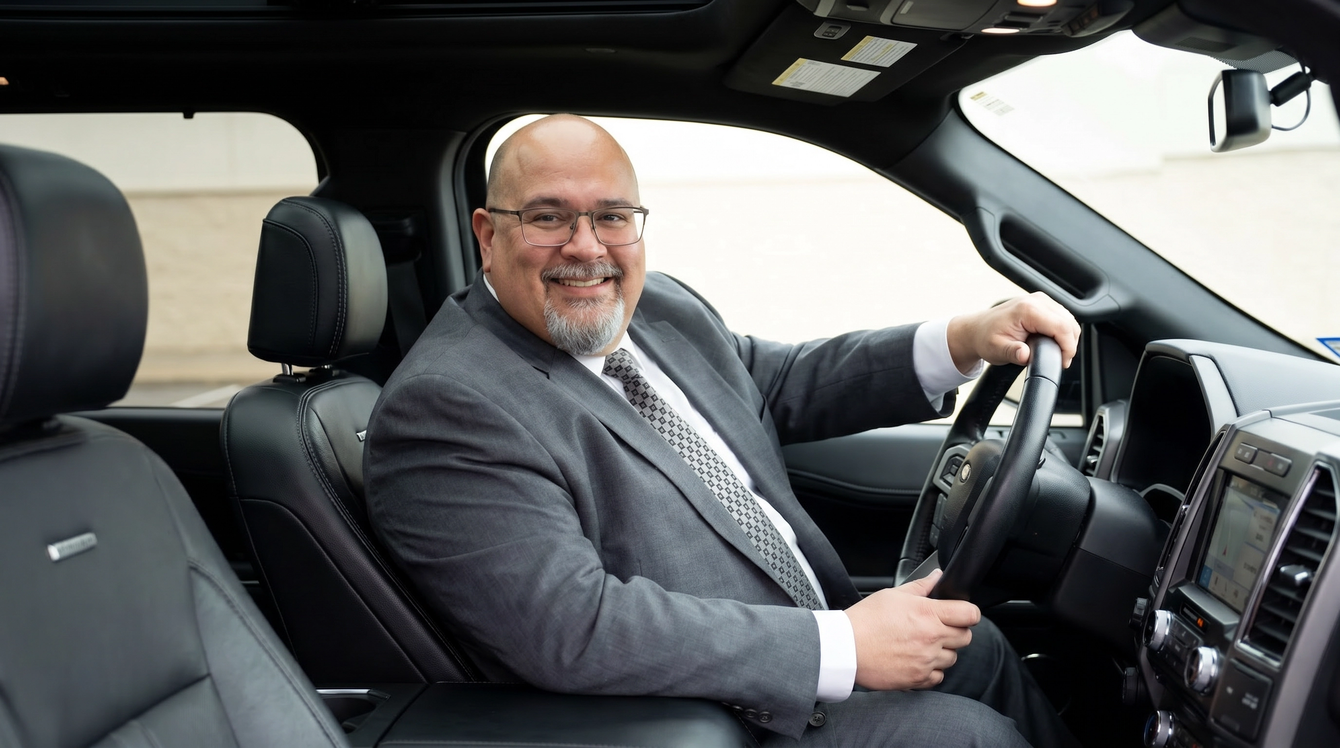 JVS Services professional chauffeur in suit beside luxury black SUV Cleveland Ohio